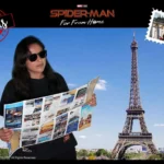 A woman in sunglasses reads a map before the Eiffel Tower, with Spider-Man: Far From Home and Paris-themed graphics.